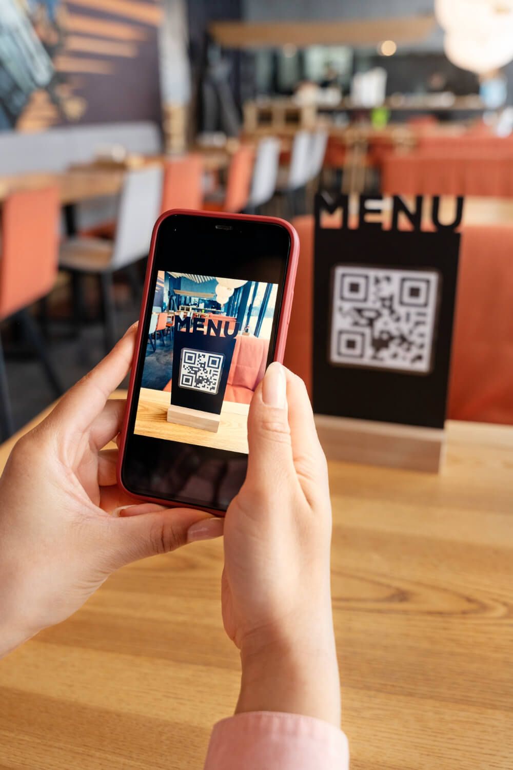 customer-at-a-restaurant-scanning-qr-code-to-see-food-menu.jpg