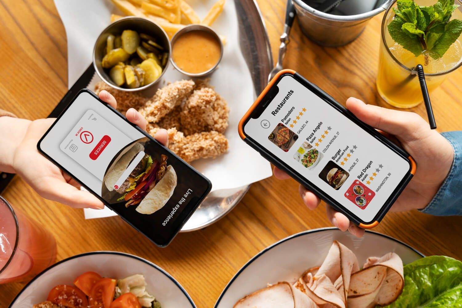 hands holding mobile phones with food delivery app screen